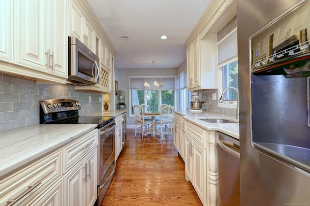 690 Forest Rd Unit 394, West Haven, CT 06516 - kitchen featuring stainless steel appliances, light wood-style floors, plenty of natural light, recessed lighting, and decorative backsplash