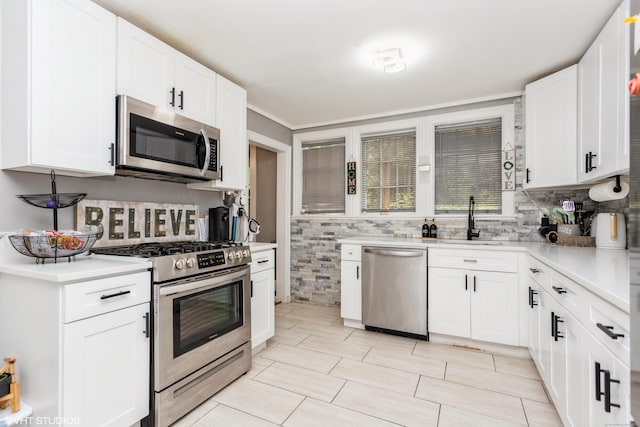 26 Trowbridge St, Waterbury, CT 06710 - kitchen with stainless steel appliances, light countertops, white cabinetry, and backsplash