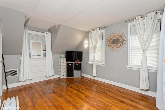 26 Trowbridge St, Waterbury, CT 06710 - unfurnished living room featuring lofted ceiling, plenty of natural light, and wood finished floors