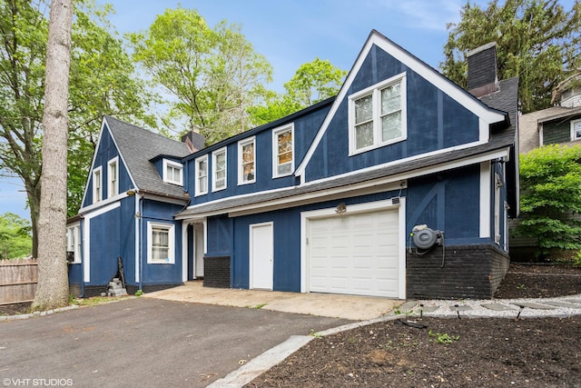 26 Trowbridge St, Waterbury, CT 06710 - view of front of house with a chimney, a garage, driveway, roof with shingles, and brick siding