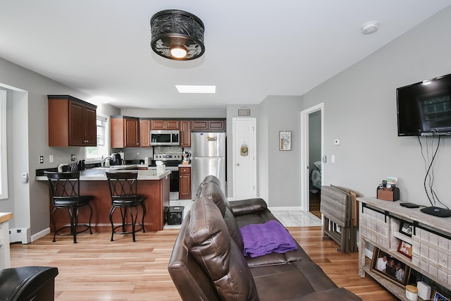 31 Bristol St, Thomaston, CT 06787 - living room featuring light wood-type flooring and baseboard heating