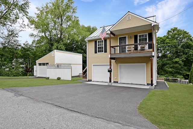 31 Bristol St, Thomaston, CT 06787 - view of front of home with a standing seam roof, asphalt driveway, a front yard, and a metal roof