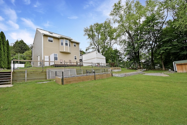 31 Bristol St, Thomaston, CT 06787 - rear view of property featuring a standing seam roof, a garden, a metal roof, and an outbuilding