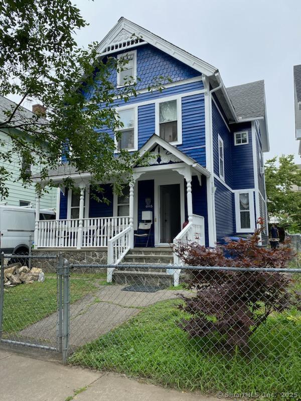 595 William St, Bridgeport, CT 06608 - victorian home with covered porch and a fenced front yard