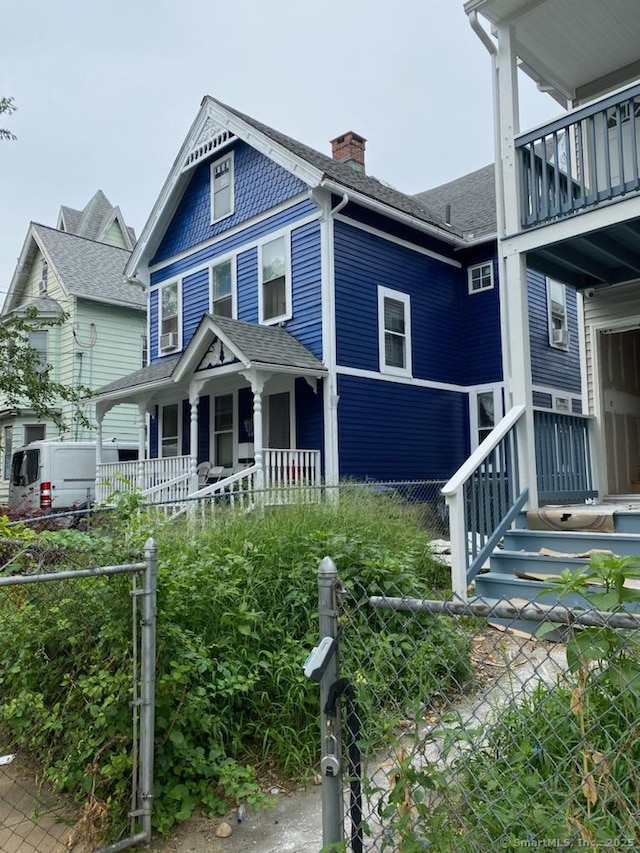595 William St, Bridgeport, CT 06608 - victorian home with a chimney, a balcony, roof with shingles, and a porch