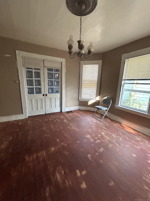 595 William St, Bridgeport, CT 06608 - unfurnished dining area with a chandelier and wood finished floors
