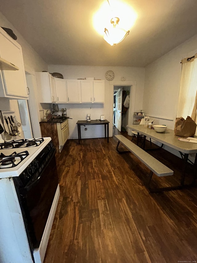 595 William St, Bridgeport, CT 06608 - kitchen with range with gas cooktop, dark wood finished floors, white cabinetry, and ventilation hood