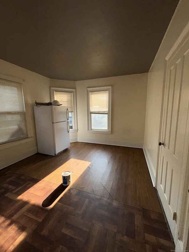 595 William St, Bridgeport, CT 06608 - unfurnished bedroom featuring freestanding refrigerator and dark wood finished floors
