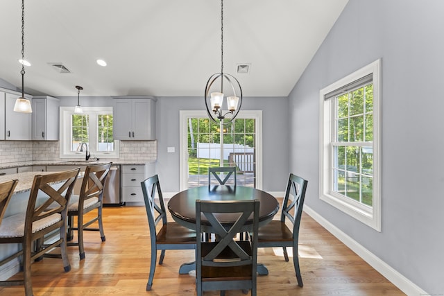 46 Airport Rd, Killingly, CT 06239 - dining space featuring healthy amount of natural light, vaulted ceiling, a chandelier, and light wood-style flooring