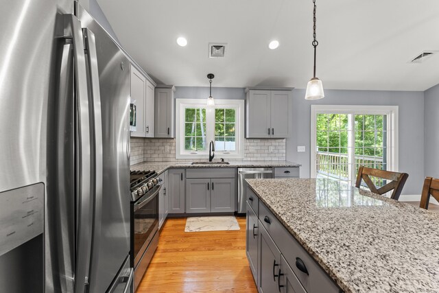 46 Airport Rd, Killingly, CT 06239 - kitchen with stainless steel appliances, gray cabinetry, decorative backsplash, light wood finished floors, and recessed lighting
