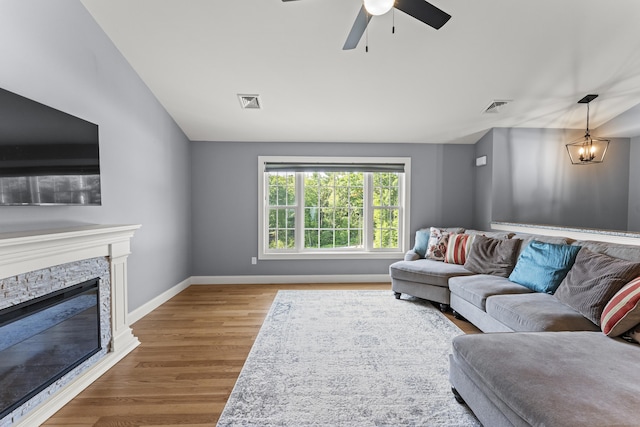 46 Airport Rd, Killingly, CT 06239 - living area featuring wood finished floors, a fireplace, a ceiling fan, and vaulted ceiling