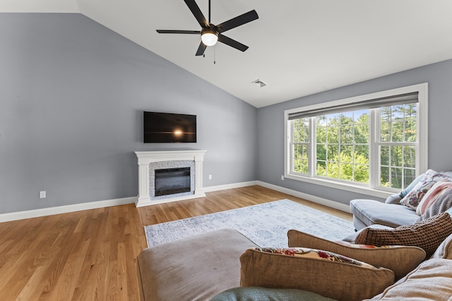 46 Airport Rd, Killingly, CT 06239 - living area featuring a ceiling fan, light wood-style flooring, a glass covered fireplace, and high vaulted ceiling
