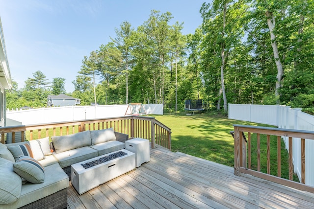 46 Airport Rd, Killingly, CT 06239 - deck featuring a trampoline, an outdoor living space with a fire pit, a fenced backyard, and view of scattered trees