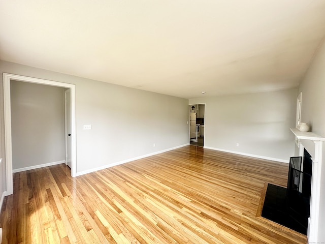 462 Halfway House Rd, Windsor Locks, CT 06096 - unfurnished living room with light wood finished floors and a fireplace with raised hearth