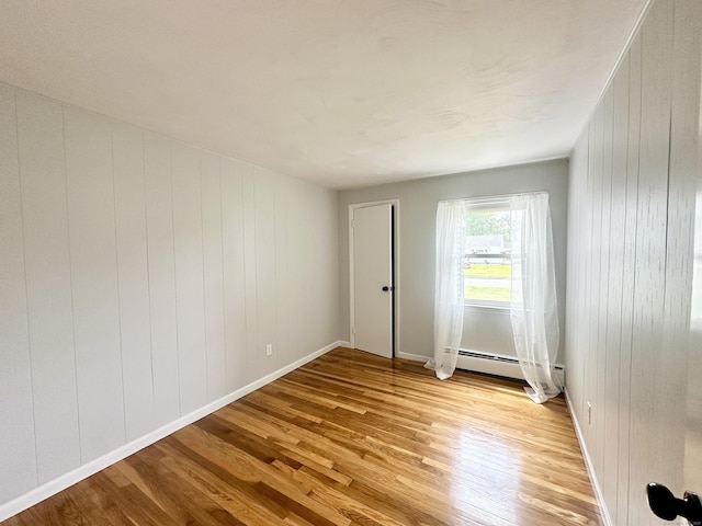 462 Halfway House Rd, Windsor Locks, CT 06096 - unfurnished room with light wood finished floors, a baseboard radiator, and wooden walls