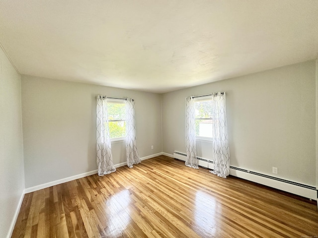 462 Halfway House Rd, Windsor Locks, CT 06096 - empty room with healthy amount of natural light, wood finished floors, and baseboard heating