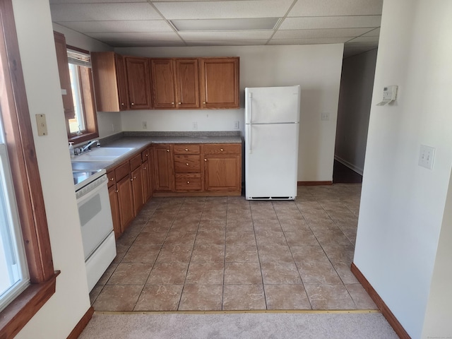 18 Hunters Ave, Norwich, CT 06380 - kitchen with white appliances, a drop ceiling, brown cabinetry, and light tile patterned floors