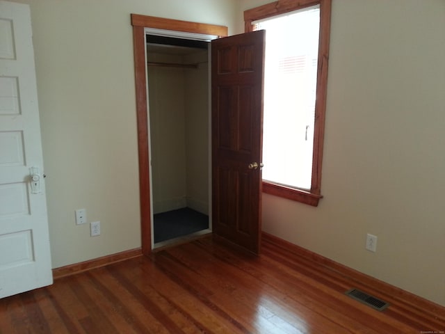 18 Hunters Ave, Norwich, CT 06380 - unfurnished bedroom with dark wood-style flooring and a closet