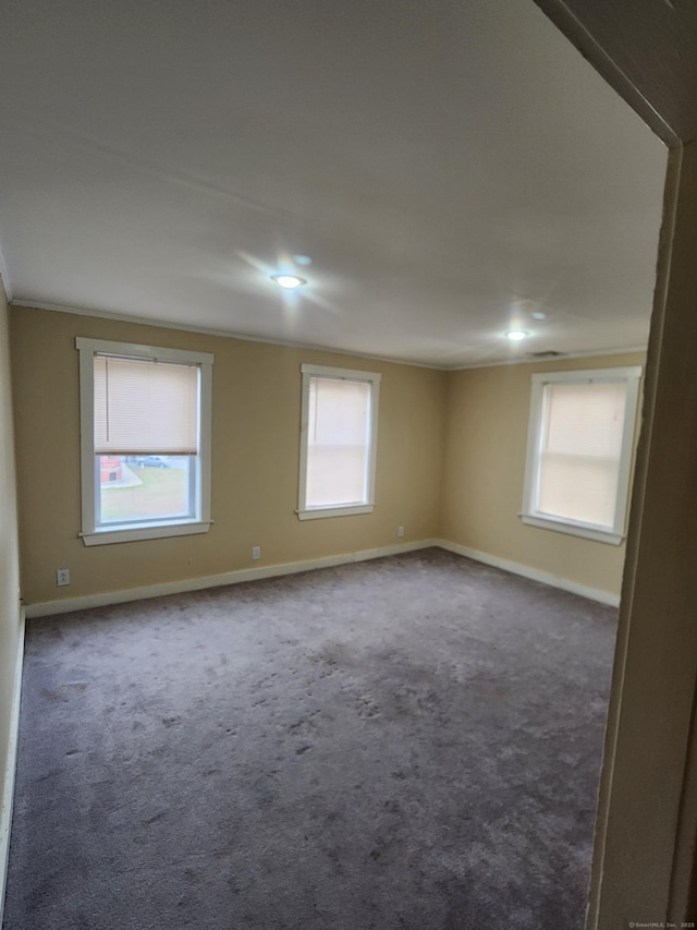 18 Hunters Ave, Norwich, CT 06380 - spare room featuring dark colored carpet, ornamental molding, and recessed lighting