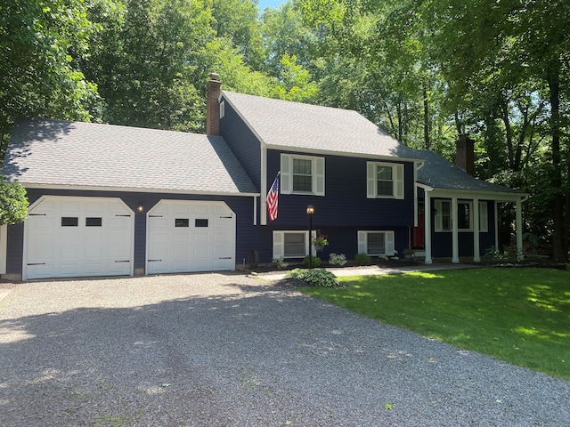 46 Twin Oak Farm Rd, Wallingford, CT 06492 - tri-level home featuring a chimney, a garage, driveway, and a front yard