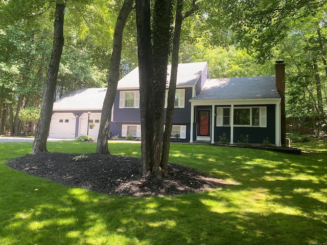 46 Twin Oak Farm Rd, Wallingford, CT 06492 - tri-level home with a chimney, a front yard, and a garage