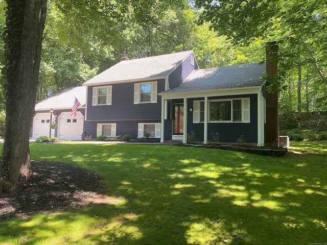 46 Twin Oak Farm Rd, Wallingford, CT 06492 - tri-level home featuring a chimney, a garage, a front lawn, and a shingled roof