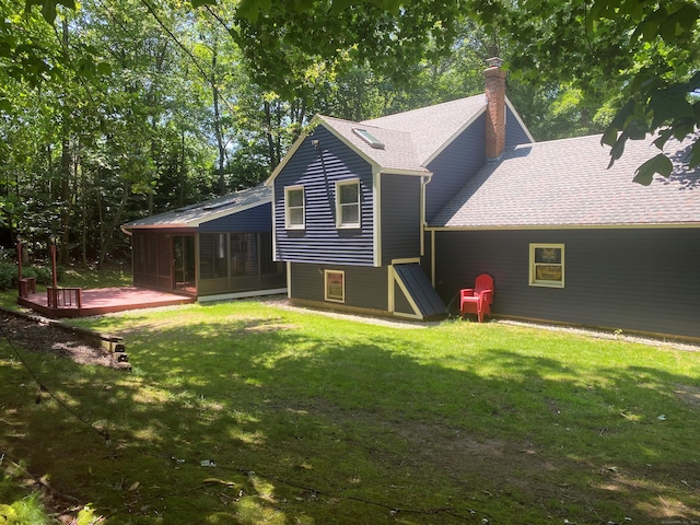 46 Twin Oak Farm Rd, Wallingford, CT 06492 - back of property featuring a sunroom, a chimney, a deck, a lawn, and a shingled roof