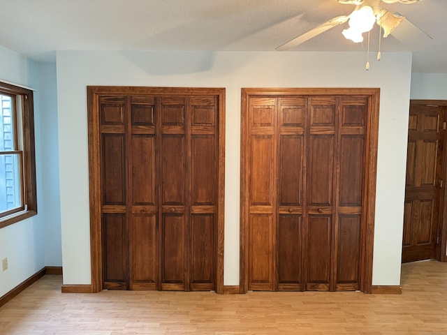 394 Merrow Rd, Coventry, CT 06238 - unfurnished bedroom with light wood finished floors, multiple closets, and ceiling fan