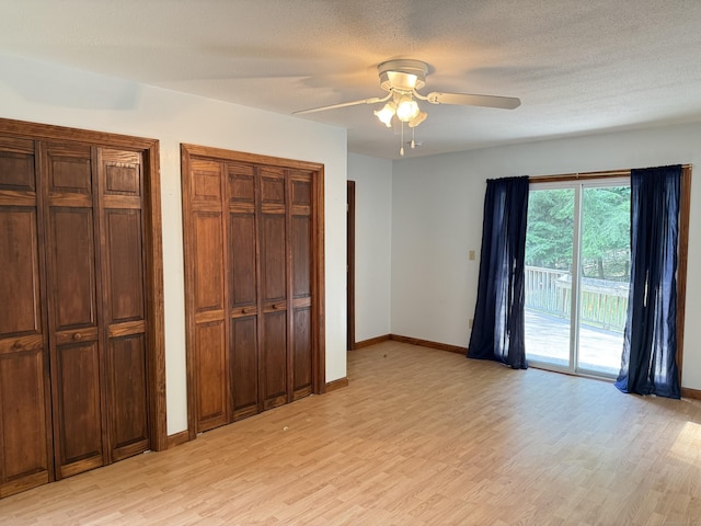 394 Merrow Rd, Coventry, CT 06238 - unfurnished bedroom with access to exterior, light wood-style flooring, two closets, and ceiling fan
