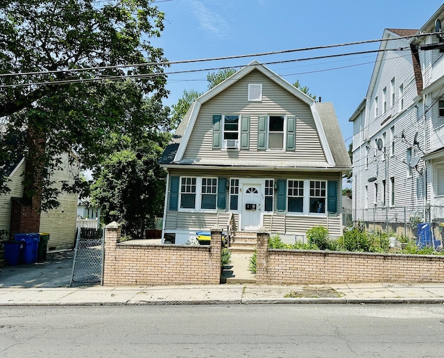 182 Oak St, Waterbury, CT 06704 - colonial inspired home with a gambrel roof, entry steps, and a gate