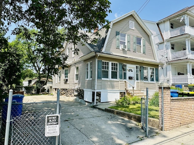 182 Oak St, Waterbury, CT 06704 - view of front of home with a gambrel roof, a fenced front yard, and a gate