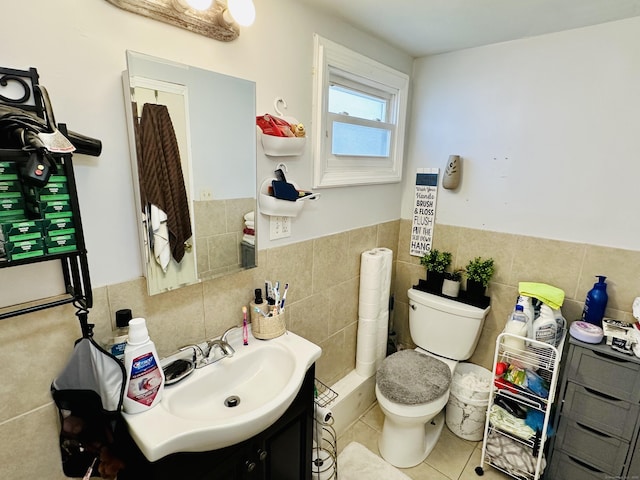 182 Oak St, Waterbury, CT 06704 - half bathroom with tile walls, vanity, tile patterned floors, and a wainscoted wall