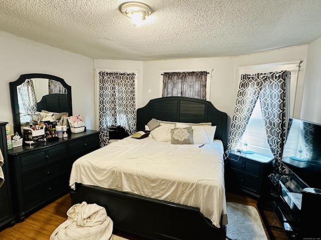 182 Oak St, Waterbury, CT 06704 - bedroom with a textured ceiling and dark wood-style flooring