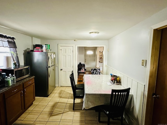 182 Oak St, Waterbury, CT 06704 - dining space with light tile patterned floors and wainscoting