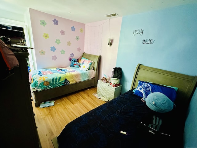 182 Oak St, Waterbury, CT 06704 - bedroom with wallpapered walls and light wood-style floors