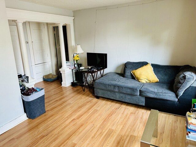 182 Oak St, Waterbury, CT 06704 - living area with decorative columns and light wood finished floors