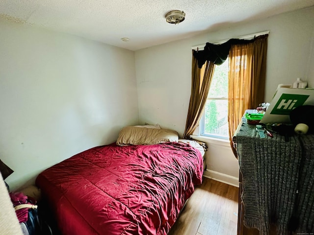 182 Oak St, Waterbury, CT 06704 - bedroom featuring wood finished floors and a textured ceiling