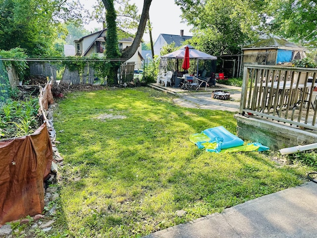 182 Oak St, Waterbury, CT 06704 - fenced backyard with an outdoor fire pit, a gazebo, a patio, and a wooden deck
