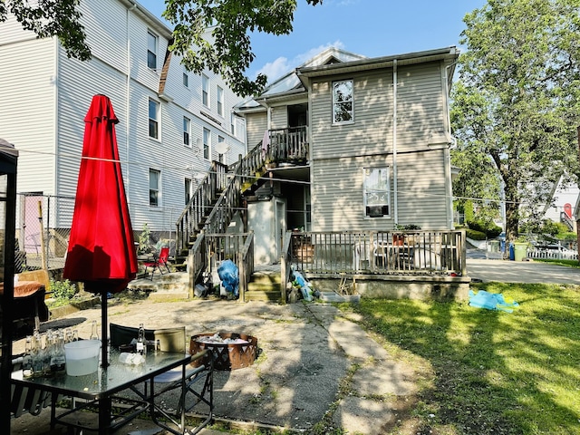 182 Oak St, Waterbury, CT 06704 - back of property featuring a fire pit, stairs, a patio, a lawn, and a wooden deck