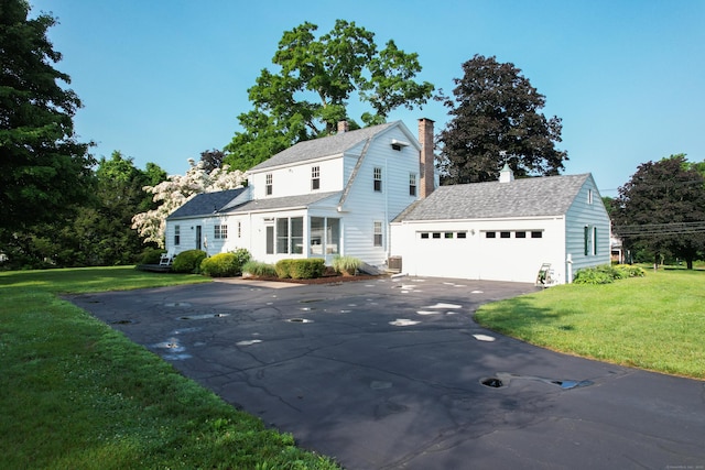 22 Spring Rd, North Haven, CT 06473 - dutch colonial featuring driveway, a chimney, a front lawn, and an attached garage