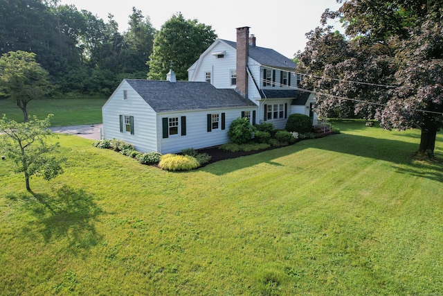 22 Spring Rd, North Haven, CT 06473 - rear view of house with a chimney, a lawn, and roof with shingles