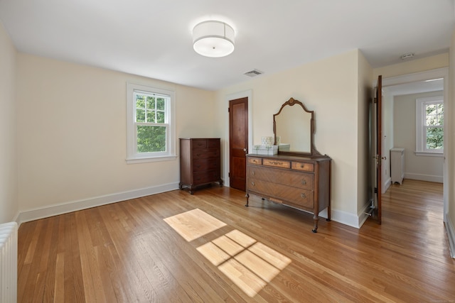 22 Spring Rd, North Haven, CT 06473 - bedroom featuring multiple windows, light wood finished floors, and radiator