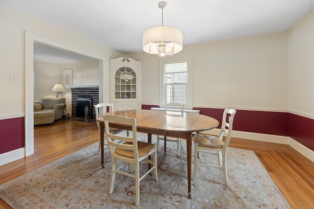 22 Spring Rd, North Haven, CT 06473 - dining space with a fireplace, wood finished floors, and a chandelier