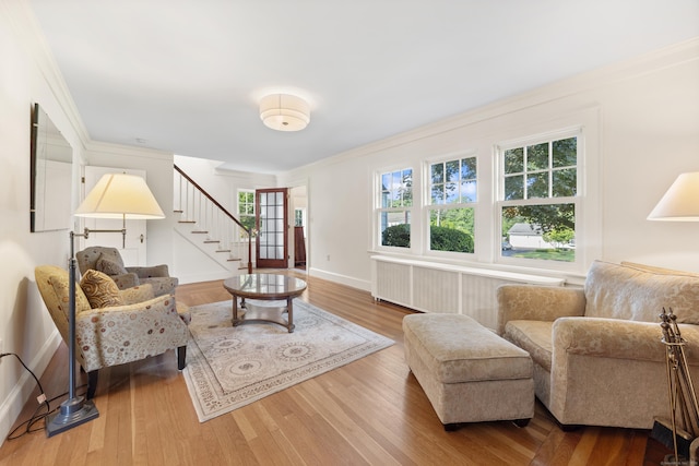 22 Spring Rd, North Haven, CT 06473 - living area with wood finished floors, stairs, radiator, and ornamental molding