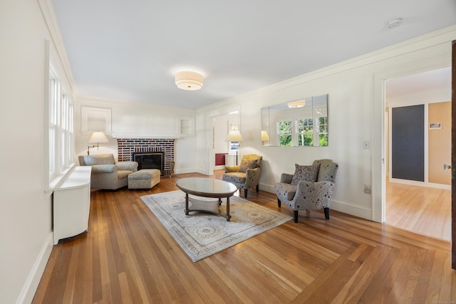 22 Spring Rd, North Haven, CT 06473 - living area with a brick fireplace, ornamental molding, and wood finished floors