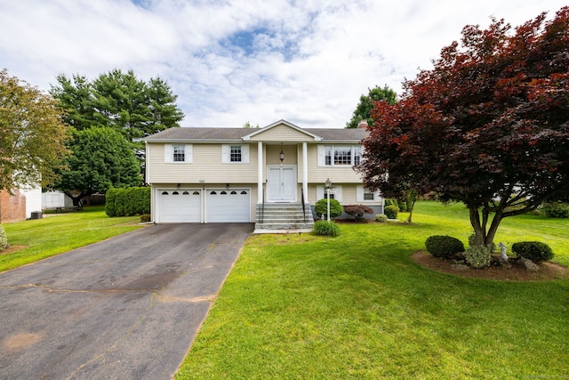 100 Chestnut Rd, Newington, CT 06111 - raised ranch with asphalt driveway, a garage, and a front lawn