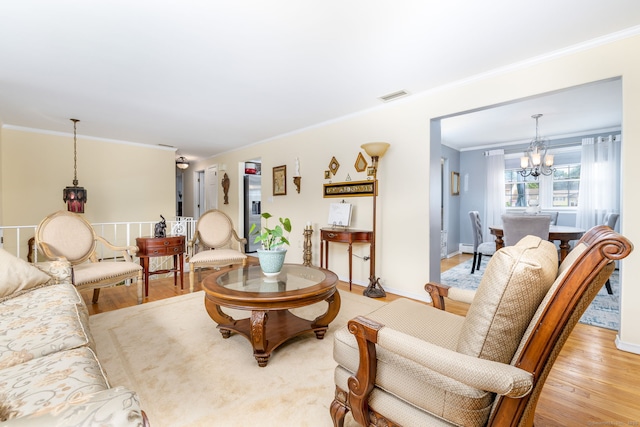 100 Chestnut Rd, Newington, CT 06111 - living room with a chandelier, ornamental molding, and light wood-type flooring