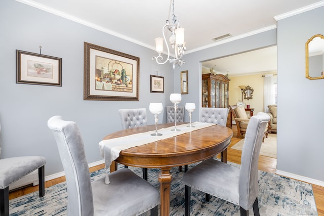 100 Chestnut Rd, Newington, CT 06111 - dining space featuring light wood-type flooring, a chandelier, and crown molding