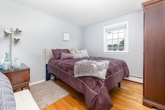 100 Chestnut Rd, Newington, CT 06111 - bedroom with baseboard heating and light wood-style floors