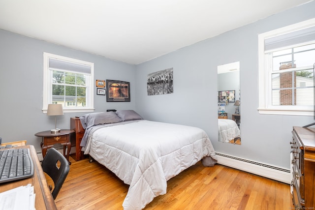 100 Chestnut Rd, Newington, CT 06111 - bedroom featuring baseboard heating, light wood-style flooring, and a baseboard radiator